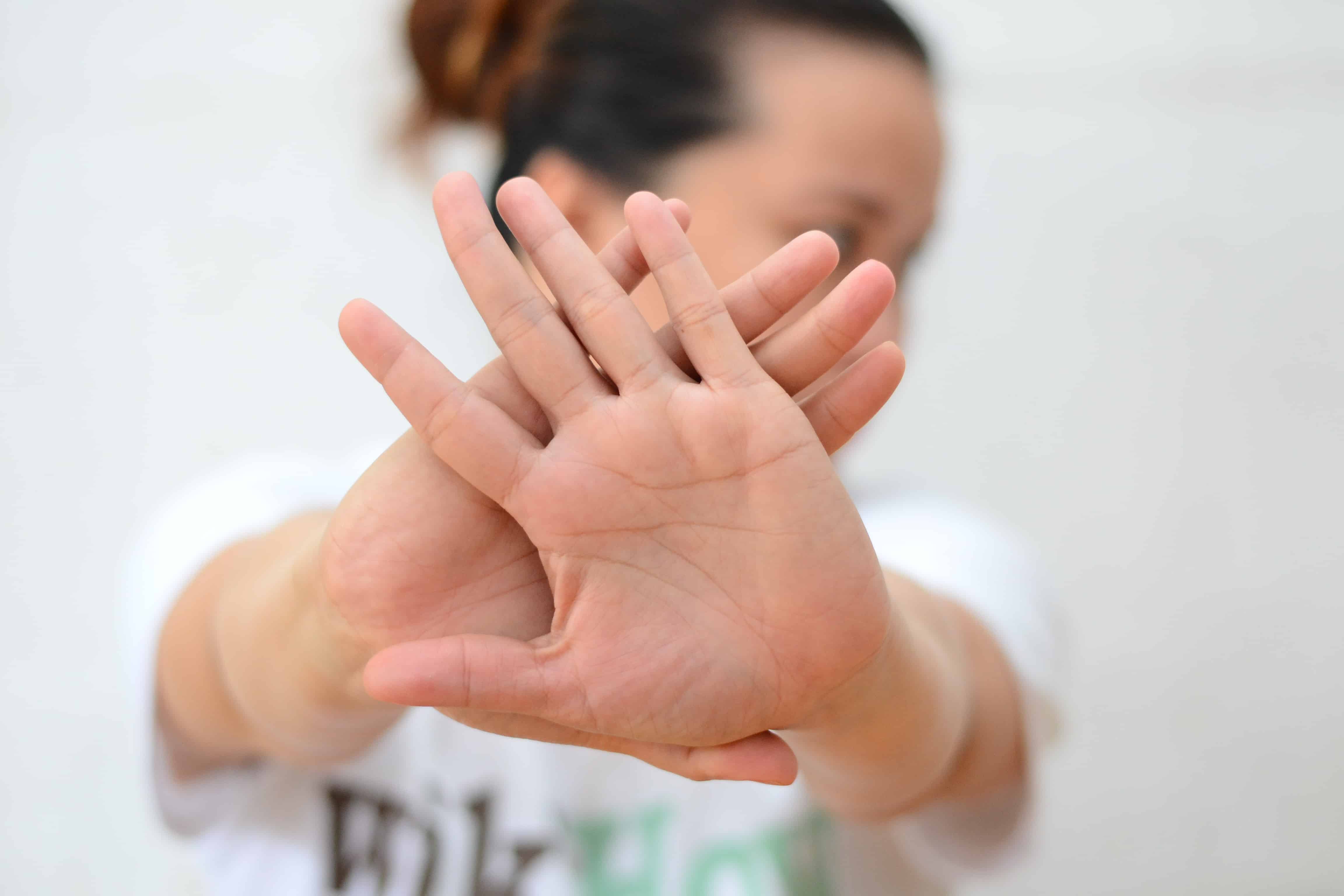 A woman acting out the gesture of 'avoid'.