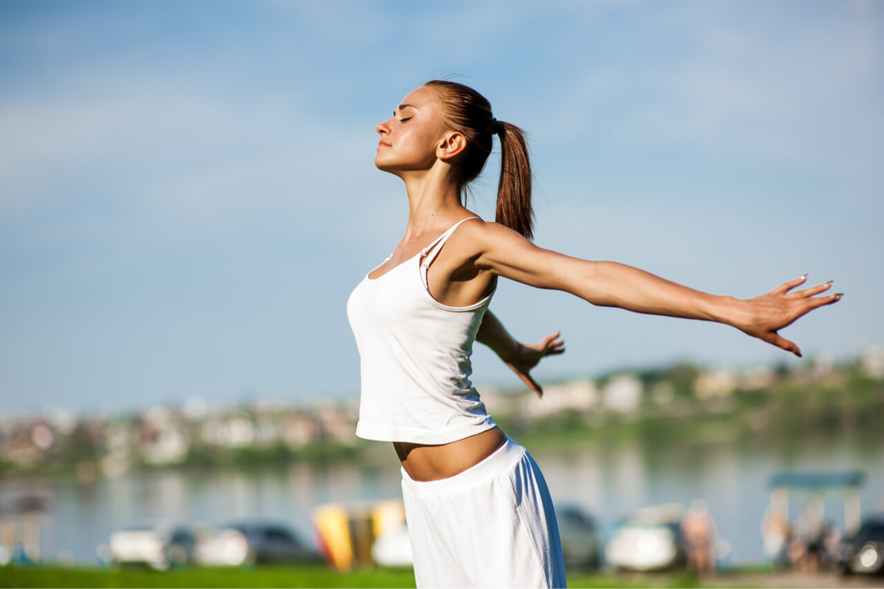 A woman stretching her body to maintain a healthy physique