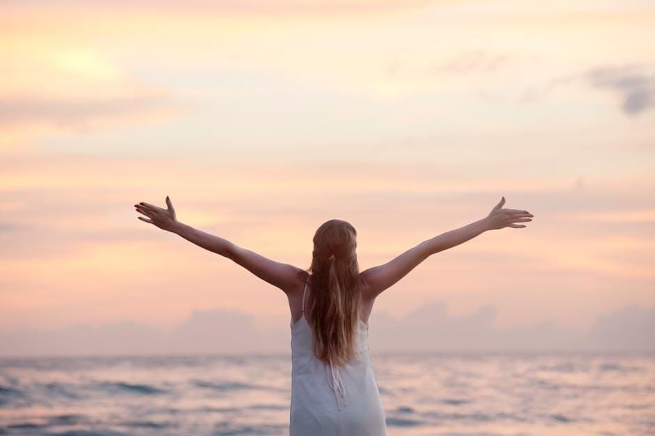 A woman with both arms raised, living in the moment.