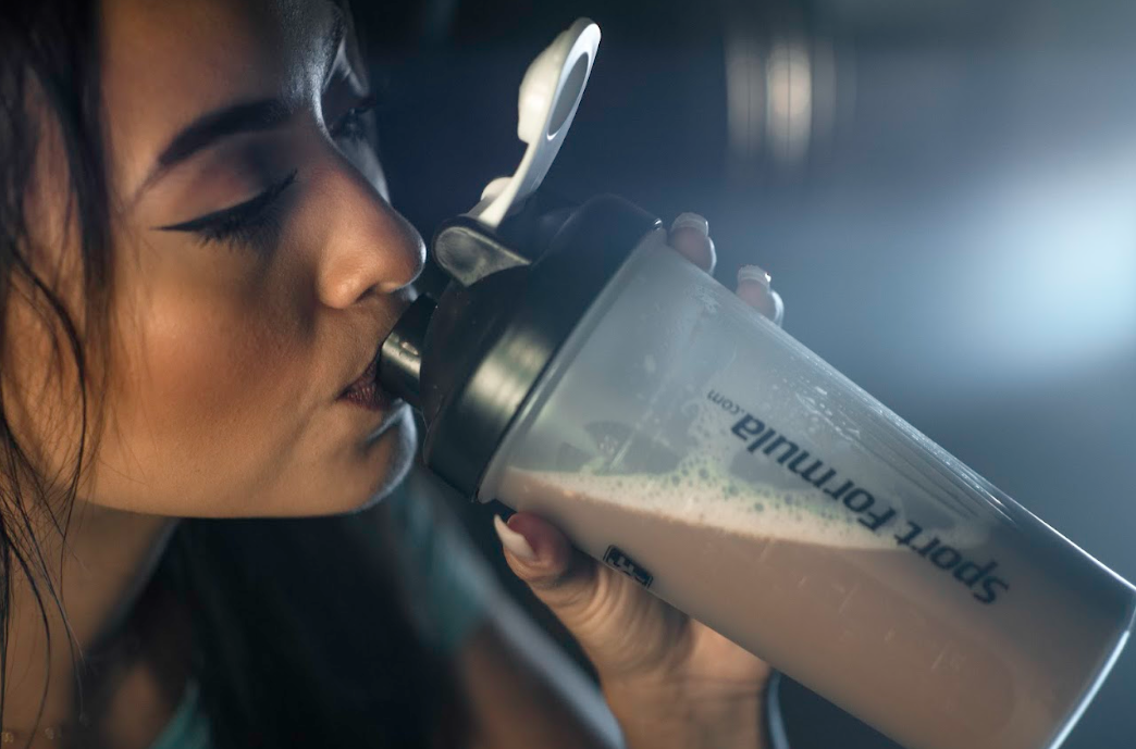 She is showing how to drink the mixed chickpea powder.