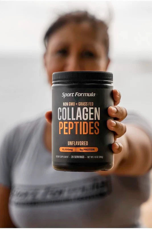 Collagen peptides held by a woman with a blurred background.