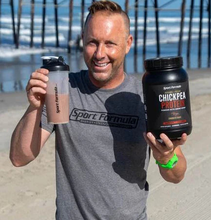 Image of a male athlete holding chickpea protein and a shaker cup