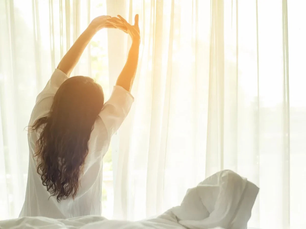 A woman stretching after just waking up in the morning