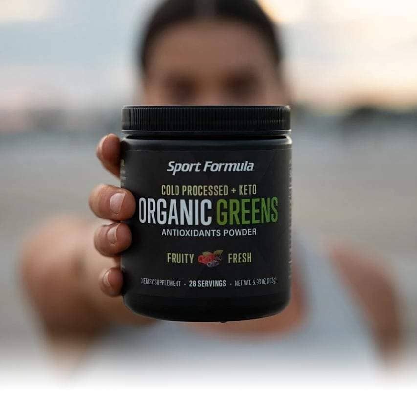 A woman holding organic greens.